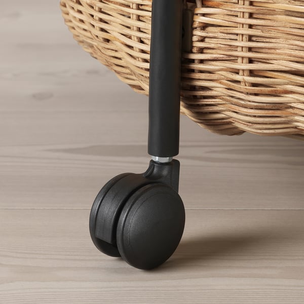 Close-up of a wicker trolley wheel, showcasing quality weave and smooth caster.