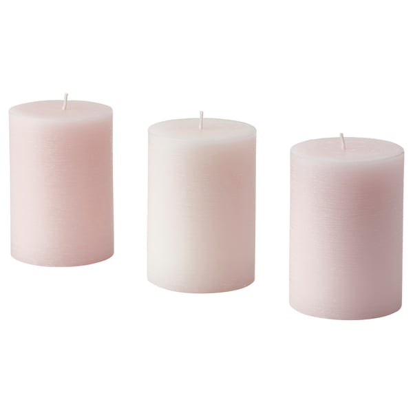 Three pink pillar candles, neatly lined up. Made of plant-based wax, each with a cotton wick. Simple, elegant design for home decor.