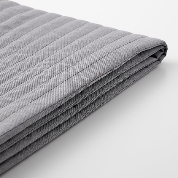 Folded grey quilted cushion cover with smooth texture, neatly pressed and ready for use.