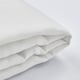 Folded white fabric with a smooth texture, zipped edge visible, laid on light background.