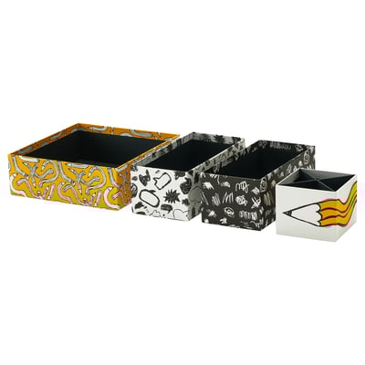 Four colourful, patterned storage boxes in yellow, white, and black; designed with abstract shapes, perfect for organising items.
