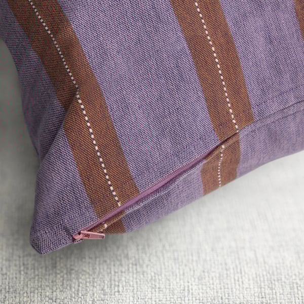 Purple and orange striped pillow with zip detail, handwoven with embroidery.