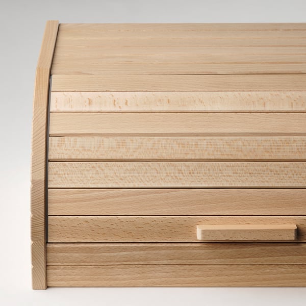 Wooden drawer unit with sleek, light finish and clean lines, ideal for modern kitchen storage.