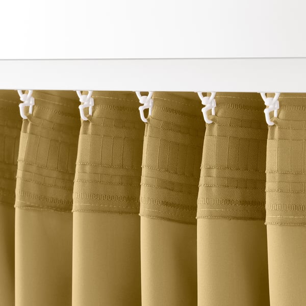 Four beige-yellow curtains hang with white clips, designed for room darkening and privacy.