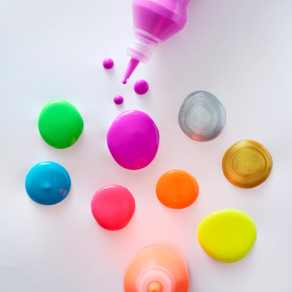 MÅLA paints squeezed onto white surface showing pink, green, blue, and yellow colours.