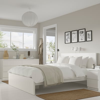 Modern white bedroom with MALM bed, two nightstands, and dresser. Large bed with coordinated furniture, neat and stylish.