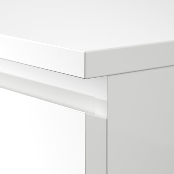 White wooden furniture close-up, showcasing sleek design and crisp finish.