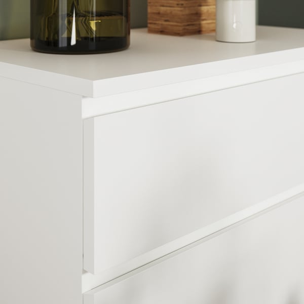 White MALM chest with smooth drawers, quality craftsmanship, clean minimalist design.
