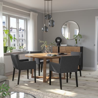 Modern dining set with grey MÅRENÄS chairs, round table, and pendant lights, brightened by large windows.