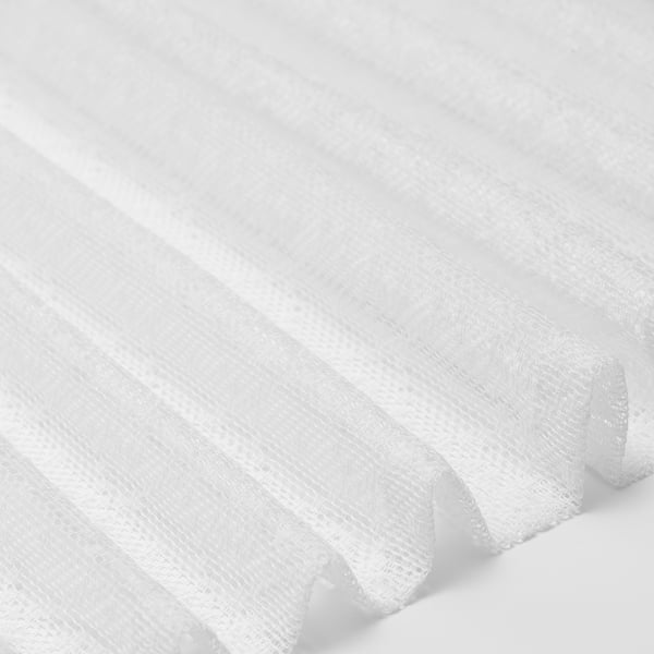 Sheer white curtains, neatly folded, showcasing quality fabric and elegant texture.