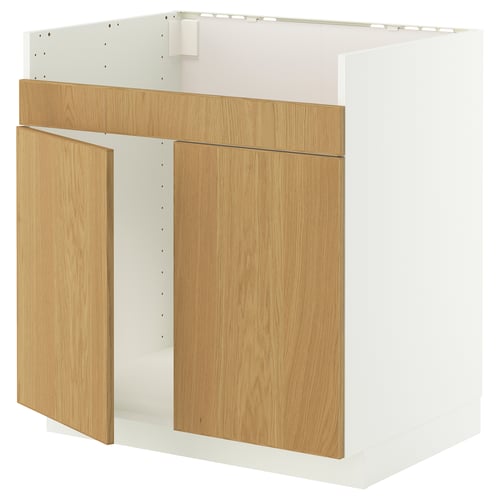A white and light wood kitchen cabinet with an open door. It combines modern design and natural materials for a sleek, functional look.