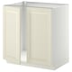A white METOD kitchen cabinet with two off-white bevelled doors. It has a sturdy frame and snap-on hinges.
