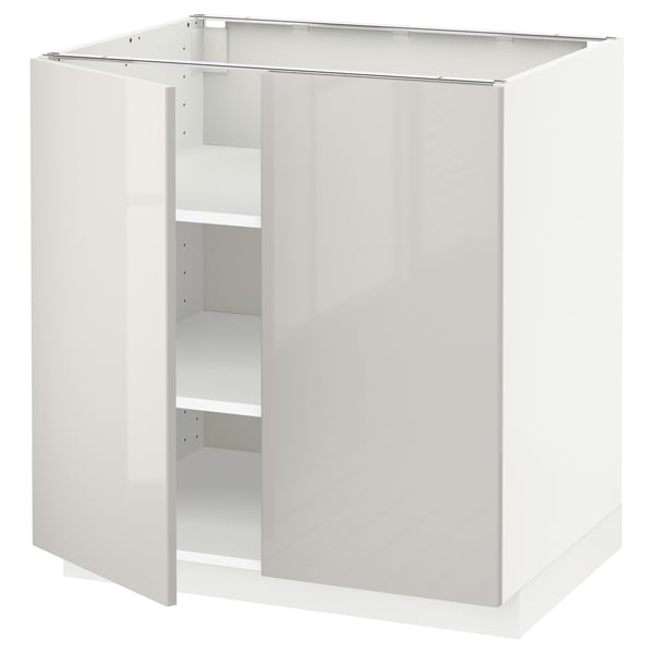 White high-gloss kitchen cabinet with one open door, sleek modern design.