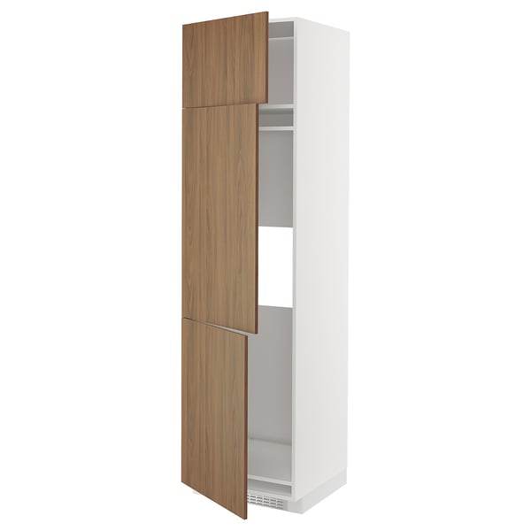 A white METOD kitchen cabinet with walnut wood-like doors open, revealing adjustable shelves inside.