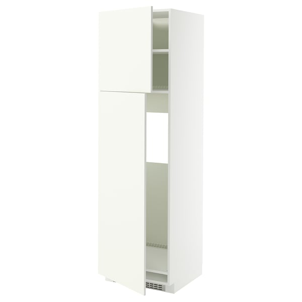 A white METOD kitchen cabinet with a single door open, revealing adjustable shelves inside.