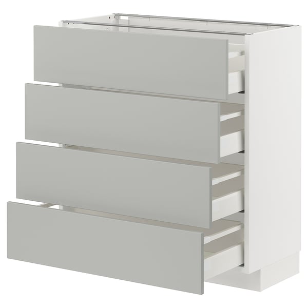 A white METOD kitchen cabinet with light grey havstorp drawers, offering modern, clean storage.