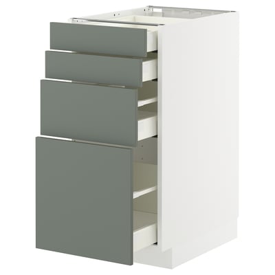 A METOD kitchen unit with four grey-green drawers and a white cabinet, featuring a sleek modern design.
