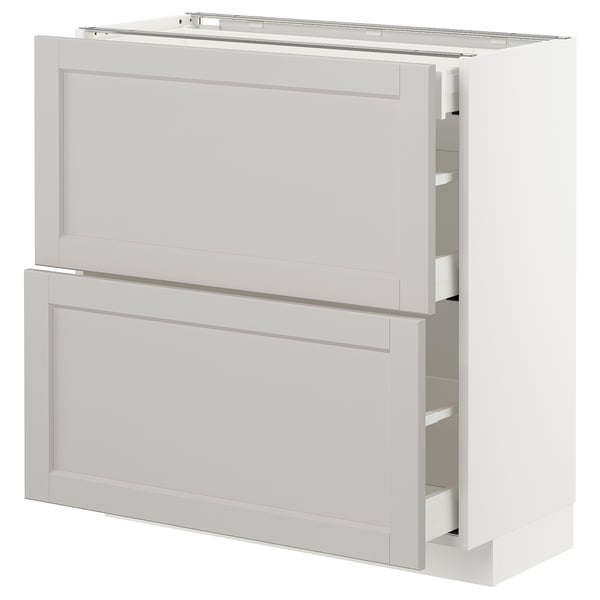 A white METOD kitchen cabinet unit with two drawers and a door, featuring a classic design with bevelled edges.