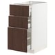 A white METOD kitchen cabinet with three dark brown sinarp drawers featuring solid wood edges.