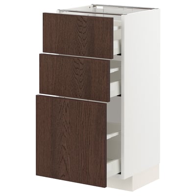 Modern kitchen unit: METOD with dark brown sinarp drawers, oak veneer, white base, three drawers.