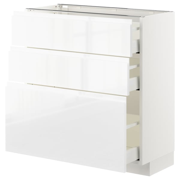 White high-gloss kitchen cabinet, modern design with sleek handles, three drawers, sturdy frame, smooth drawer runners.