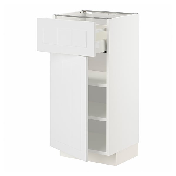 A white METOD kitchen cabinet with a drawer open, revealing shelves inside.