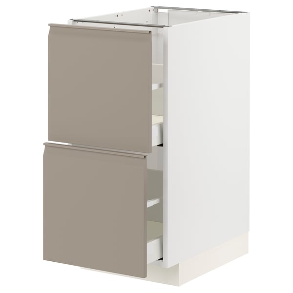 Modern kitchen cabinet in beige with integrated handles and drawers.