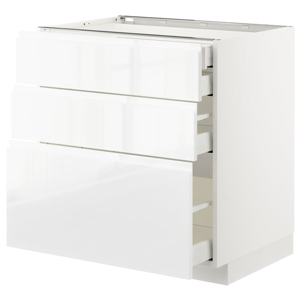 White high-gloss kitchen cabinet with three drawers and handles.