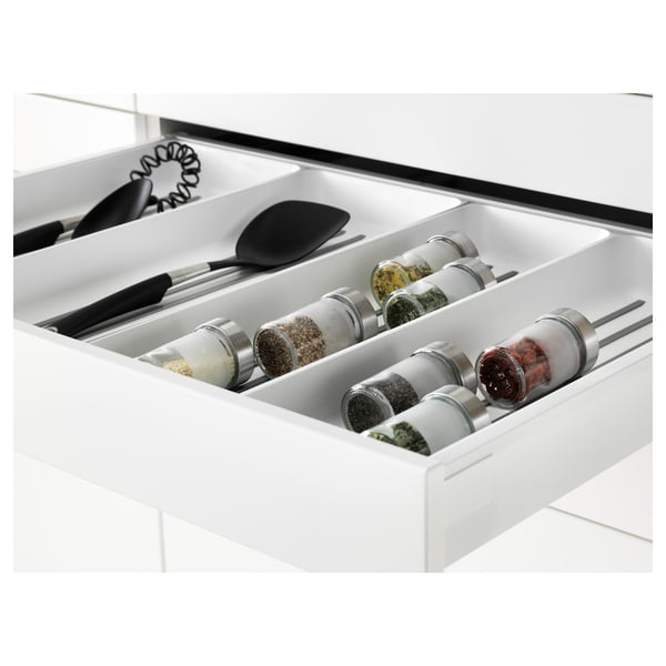 Kitchen drawer with organised spice jars and utensils, showcasing storage and accessibility.