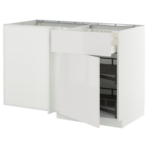 A white METOD kitchen cabinet with one door open, revealing an organized inner shelf.