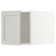 White METOD cabinet with gray interior, beveled edges, and snap hinges.