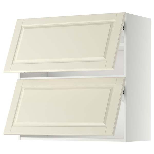 Two white METOD wall cabinets with off-white bodbyn bezels, featuring a classic design with bevelled edges.