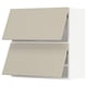 Two beige METOD kitchen cabinets with flat, angular design and smooth surfaces.