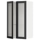 A white METOD kitchen wall cabinet with a black hejsta glass door featuring reeded glass and metal frames with integrated handles.