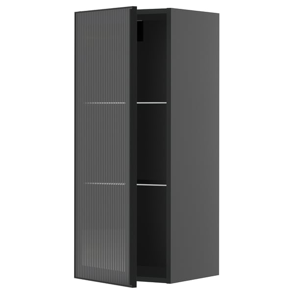 Black modern kitchen cabinet with glass door and reeded texture on frame.