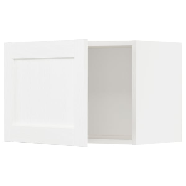 White kitchen cabinet with subtle grain, open door revealing empty space.