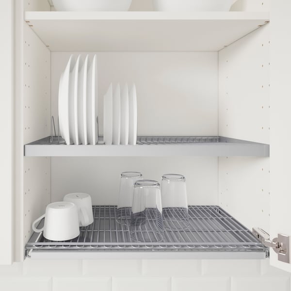Kitchen shelf unit with adjustable metal shelves, holding white plates and cups.
