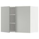 A grey METOD wall kitchen cabinet with two doors open, revealing shelves inside.