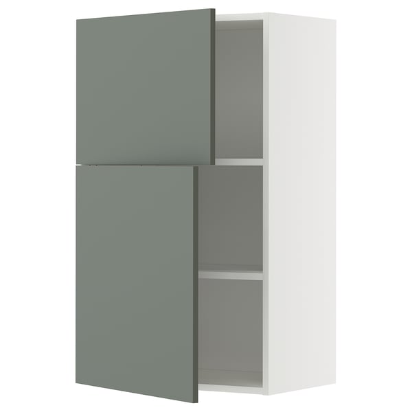 Displays a modern wall-mounted kitchen cabinet with green-gray doors and white frame, featuring adjustable shelves and a sleek design.