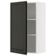 A modern METOD kitchen cabinet in white with a black door, featuring a sleek and minimalist design.