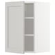 A white METOD kitchen cabinet with light grey shelves and bevelled edges.