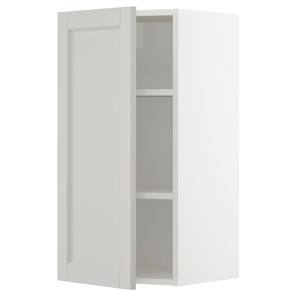 A METOD wall cabinet in white with two adjustable shelves and beveled edges.