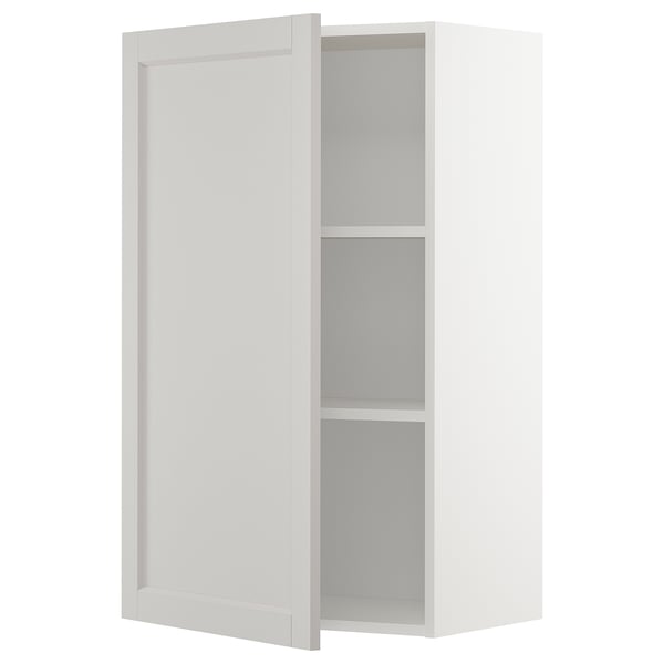 A white METOD kitchen cabinet with adjustable shelves and beveled edges.
