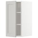 A white METOD kitchen cabinet with light grey lerhyttan fronts and adjustable shelves.
