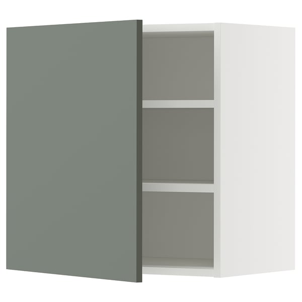 Modern kitchen cabinet with grey-green door and white shelves.