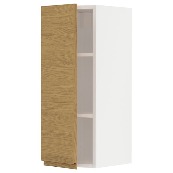 Open METOD cabinet with oak-veneer door, white interior, wall-mounted.