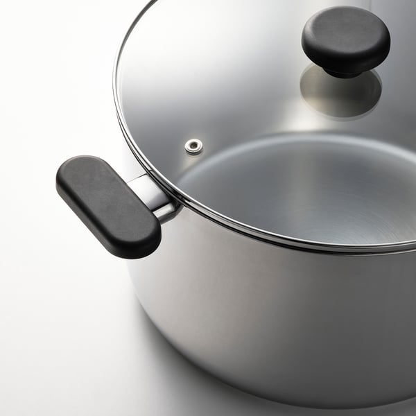 Silver saucepan with black handles and transparent lid, showcasing quality design with stainless steel finish and durable, compact structure.