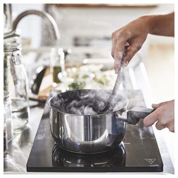 Cooking on stove with steam.