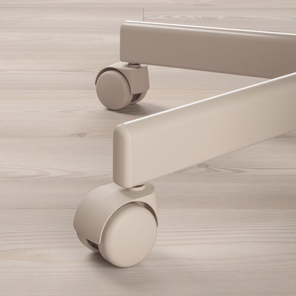 Close-up of a modern office chairs light beige casters and base on a wooden floor. Smooth swivel action and sturdy design.