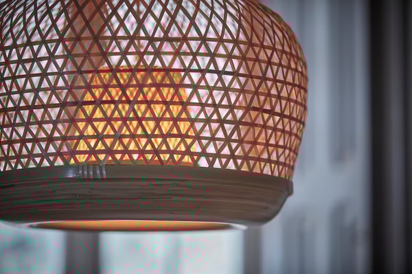 Hand-woven bamboo lamp. Brown with warm glow.